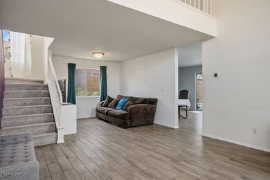 Living area with stairway, wood finished floors, a
