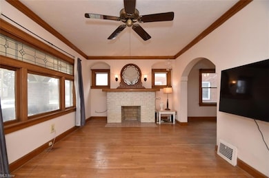 Living room- wood floors, wood burning fireplace and wood trim.
