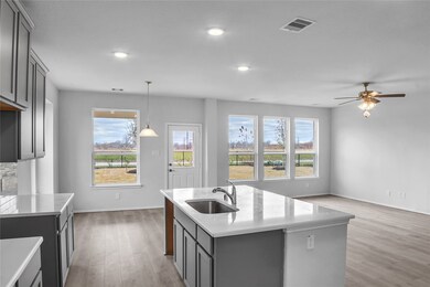 The Princeton II- Kitchen into the Family Room. Sample floor plan photo used for illustrative purposes only. Upgrades, selections options, windows and colors may vary.