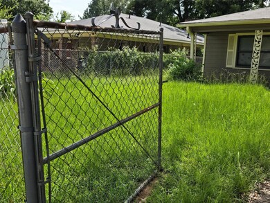 View of gate with a lawn