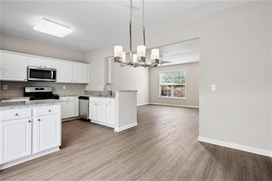 Kitchen featuring backsplash, light wood-style flo