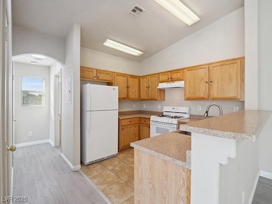 Kitchen with white appliances, under cabinet range