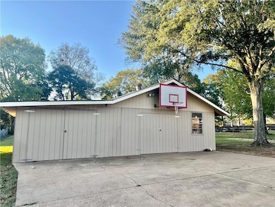 Large shop with space to store a boat and additional space for work and storage.