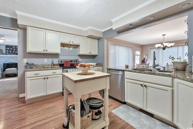 Kitchen featuring decorative light fixtures, a cha