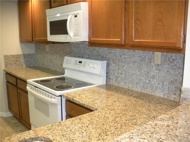 Beautiful updated granite countertops with tile ba