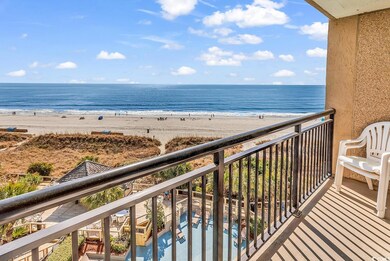 Balcony featuring a view of the beach and a water 