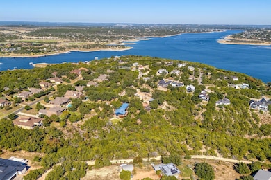 Aerial view of property and surrounding area with a nearby body of water and nearby suburban area
