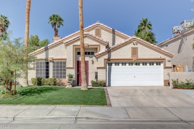 Traditional home with a garage, driveway, a front
