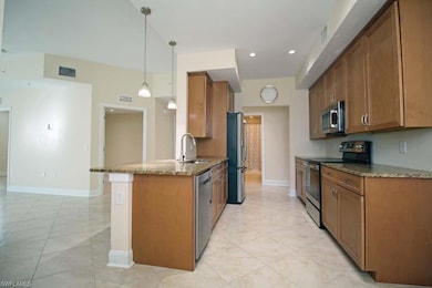 Kitchen with granite counters, sink, hanging light