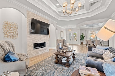 Living room with wood-type flooring, a fireplace, 