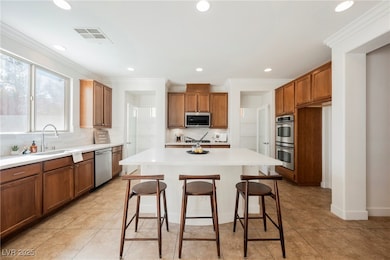 Kitchen with stainless steel appliances, a sink, b