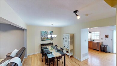 Beautiful blonde hardwood floors throughout dining