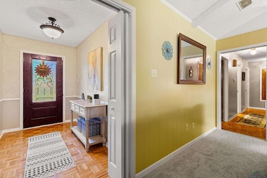 Hallway featuring a textured ceiling and baseboard