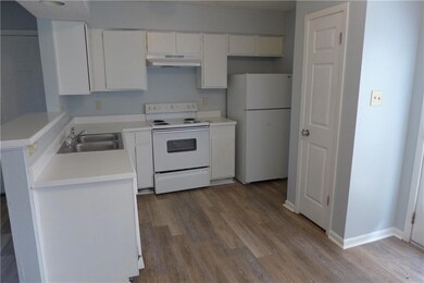 Kitchen featuring white appliances, under cabinet