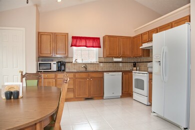 Kitchen with oak cabinets and granite countertops.