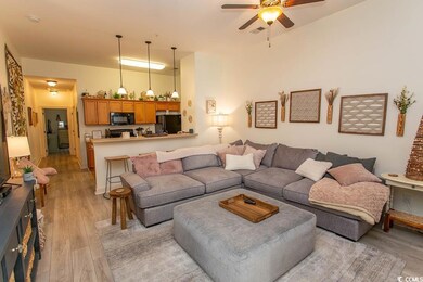Living room featuring visible vents, ceiling fan, 
