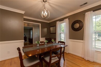 Formal dining room with updated lighting, chair ra