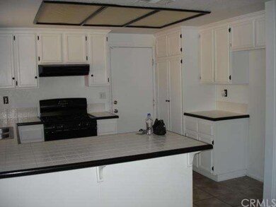 Kitchen with panty and entrance to the garage.