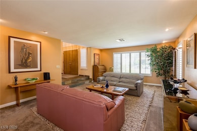 Carpeted living room with baseboards