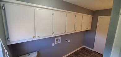 Laundry area featuring washer hookup and dark hard