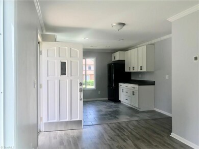 Welcome Home! Walk in to your living room and kitchen with brand new wood and tile floors and paint throughout.
