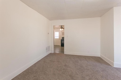 Empty room featuring baseboards, carpet flooring, 