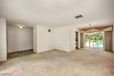 Empty room with light colored carpet and a notable