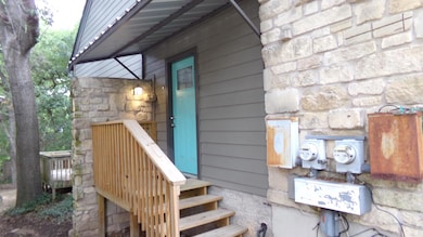 Entrance to property with stone siding