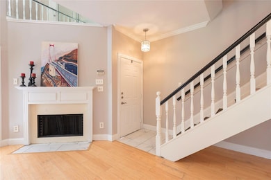 Foyer with baseboards, a fireplace, wood finished 
