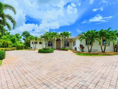 Gigantic brick pavered circular driveway with extr