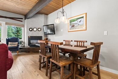 Dining room with beams, T&G wood ceiling, a firepl