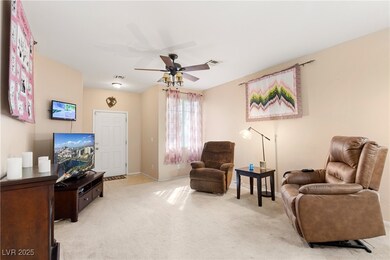 Living area featuring light carpet, visible vents,