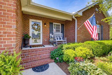 Nice rocking chair front porch and beautiful landscaping.