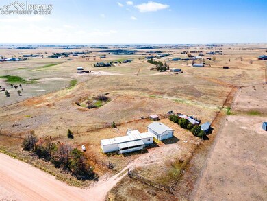 Birds eye view of property featuring a rural view