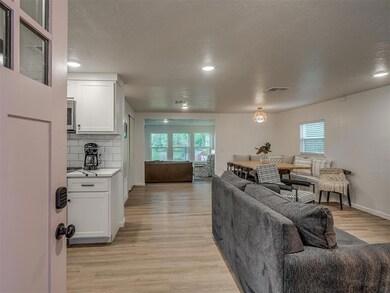 Living room featuring light wood-type flooring and a textured ceiling