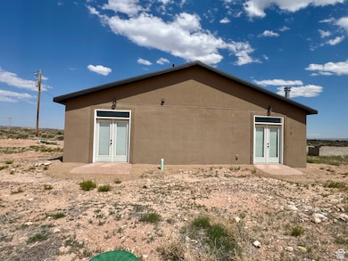 Rear view of house with french doors and stucco siding