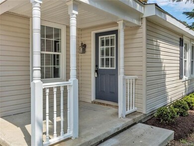 An inviting front porch leads you into an open liv