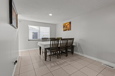 Dining area featuring light tile patterned flooring and baseboards