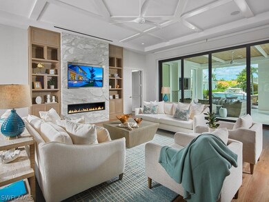 Living room featuring coffered ceiling, built in s