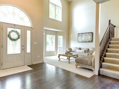 GRAND FOYER OPENING INTO 2 STORY LIVING ROOM 