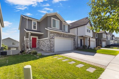 View of front of house with concrete driveway, a residential view, a garage, stone siding, and stucco siding