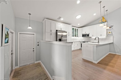 Kitchen with pendant lighting, kitchen peninsula, 