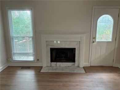 Detailed view of wood finished floors and a high end fireplace
