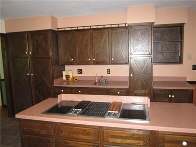 KITCHEN HAS AN ISLAND AND WET BAR.