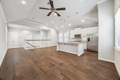 View back toward the stairs and primary suite.