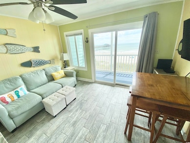 Living area with a water view, a ceiling fan, base