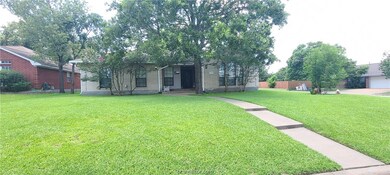Huge corner lot. Beautiful yard, walkway, & trees.
