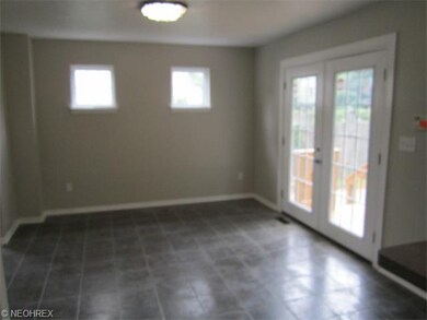 Dining room with tile floor. Patio doors lead to deck, deep yard and 2 car garage