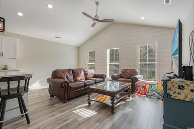 Living room with ceiling fan, light hardwood / woo