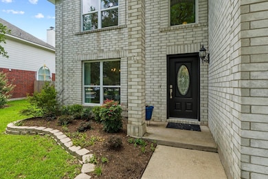 Entrance to property featuring brick siding